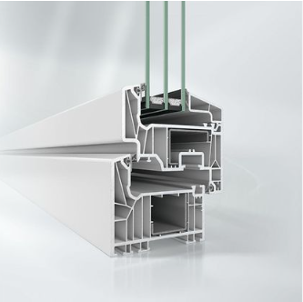 A white building with a lot of windows and trees reflected in the windows.