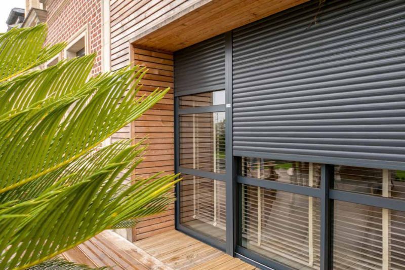 A brick building with a table and bench in front of it