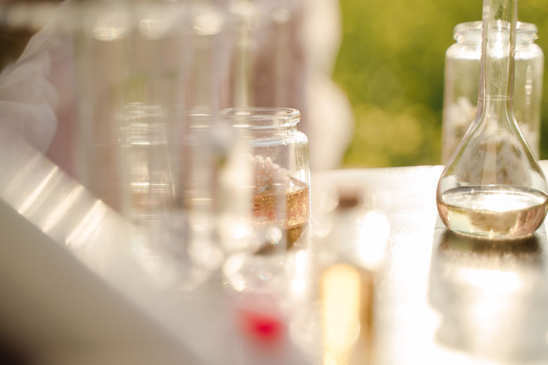 Assorted herbal remedy bottles, jars, and boxes on a wooden table with fresh mint leaves