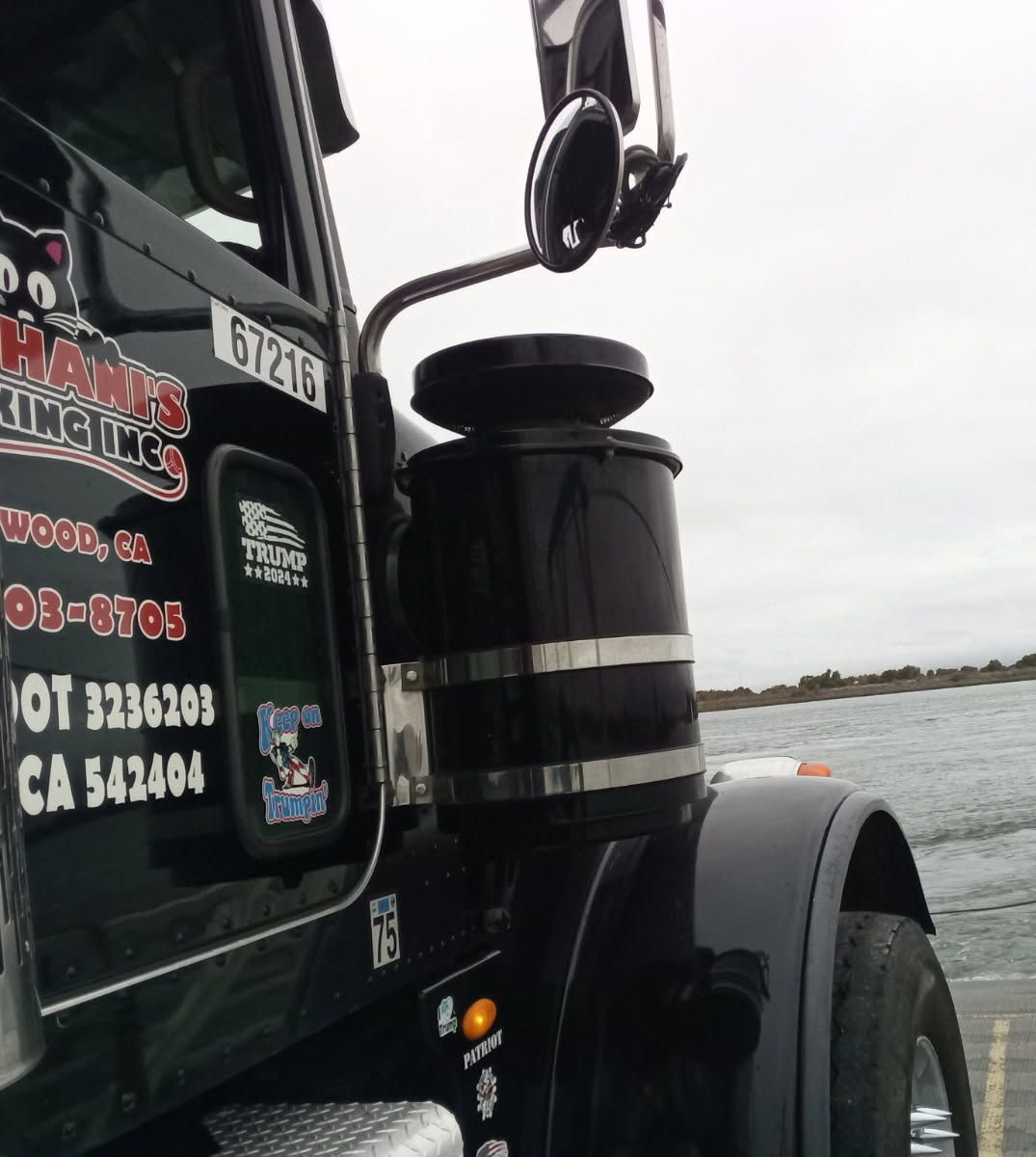 Overhead view: Dump truck and bulldozer on a cleared, brown construction site, leaving tracks