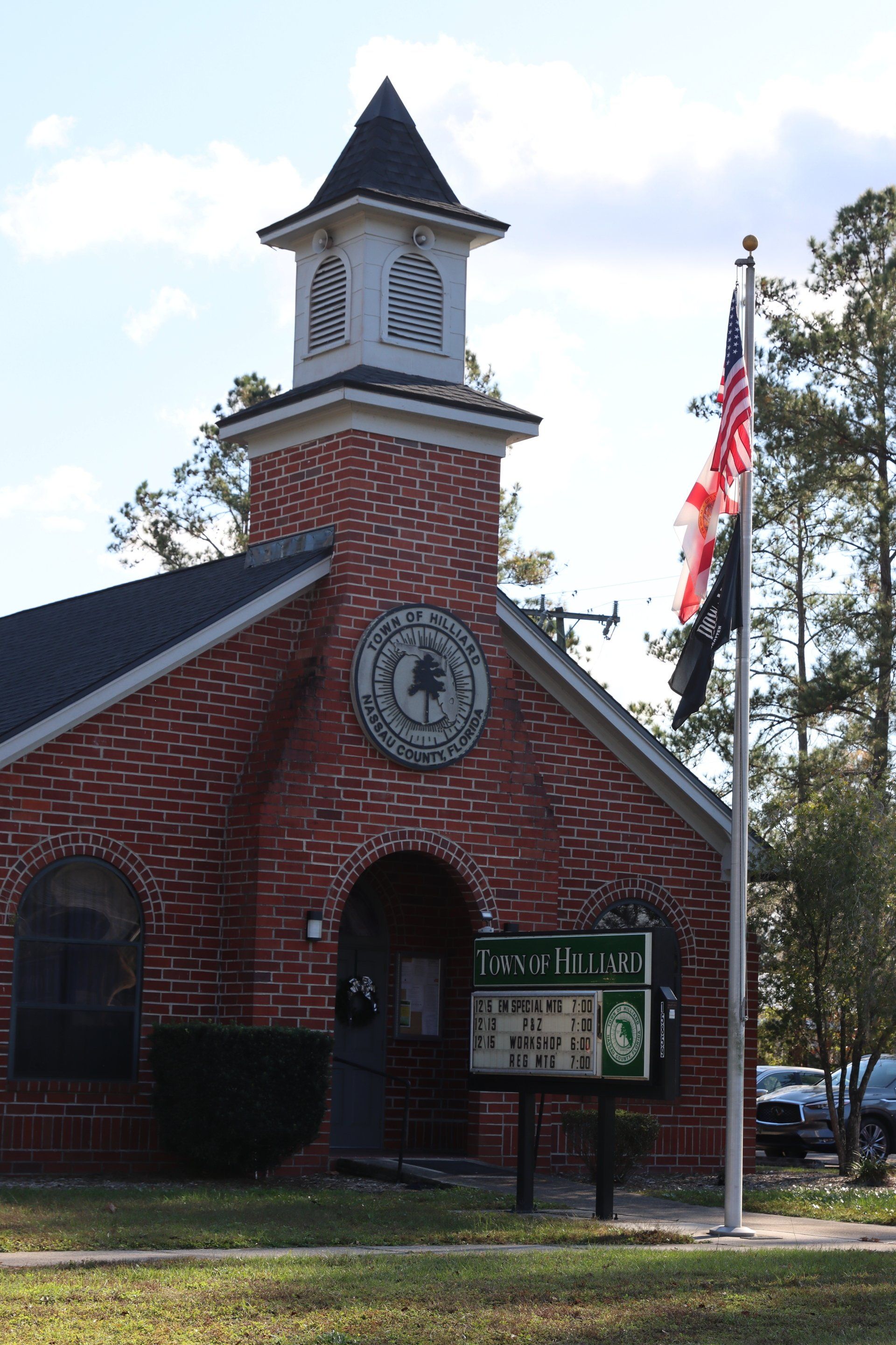 A brick church with a clock tower and a sign that says terra hills