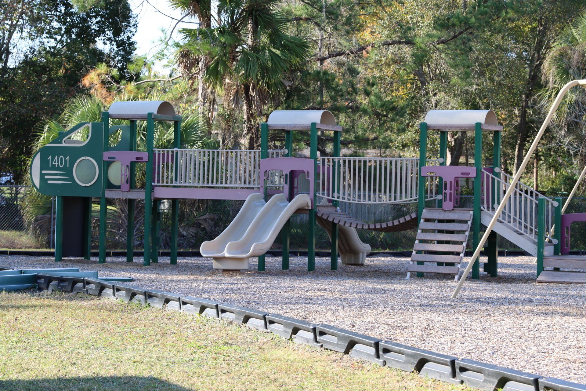 A playground with a sign that says 1301 on it