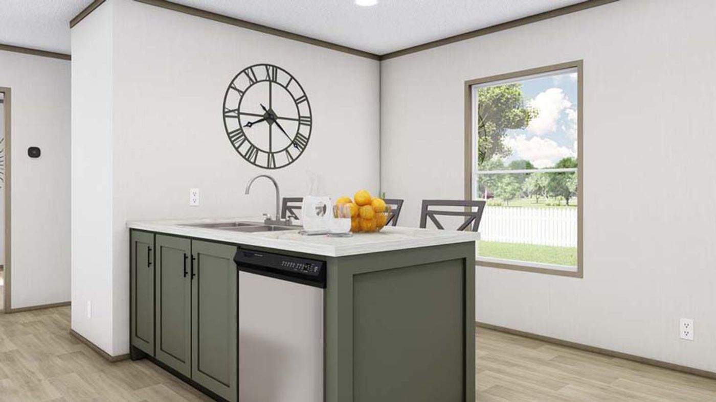 A kitchen with a large clock on the wall above the sink.