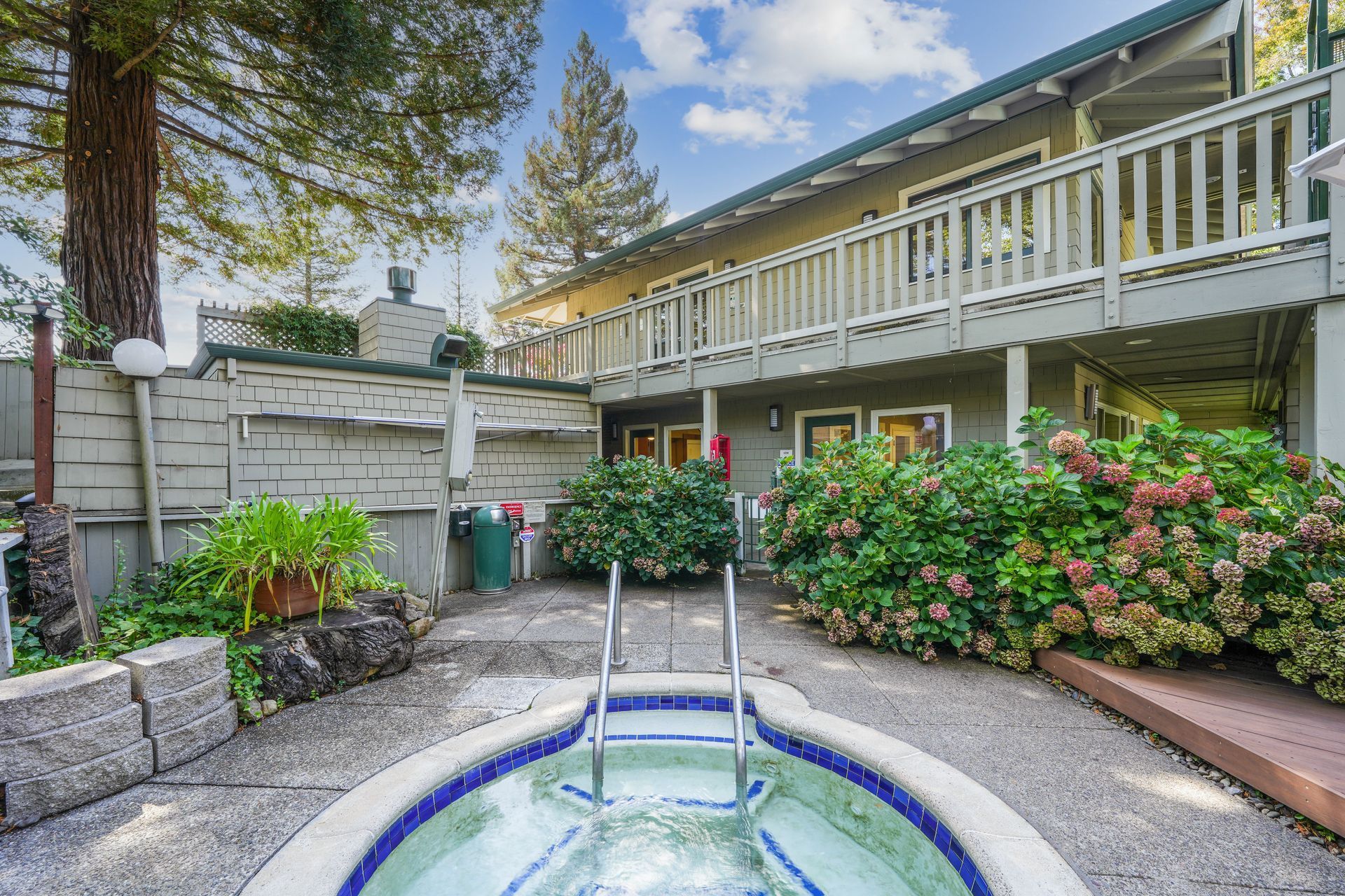There is a hot tub in the backyard of a house.