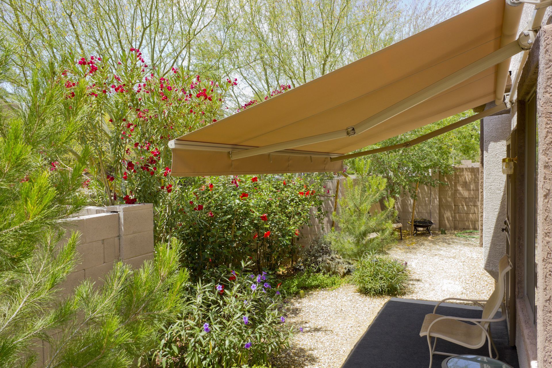 A patio with a chair and a canopy over it.