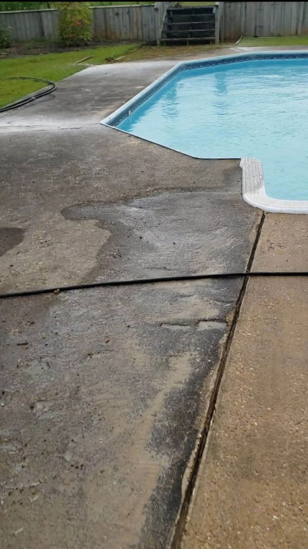 Concrete pool deck showing wet and dry areas; pool in the background.