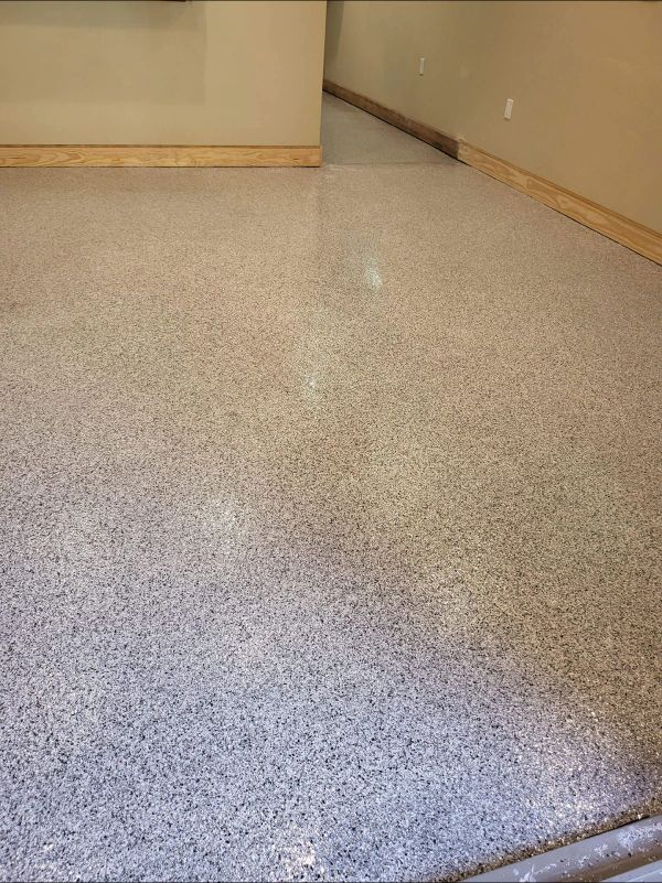Gray speckled epoxy floor with tan trim and beige walls.