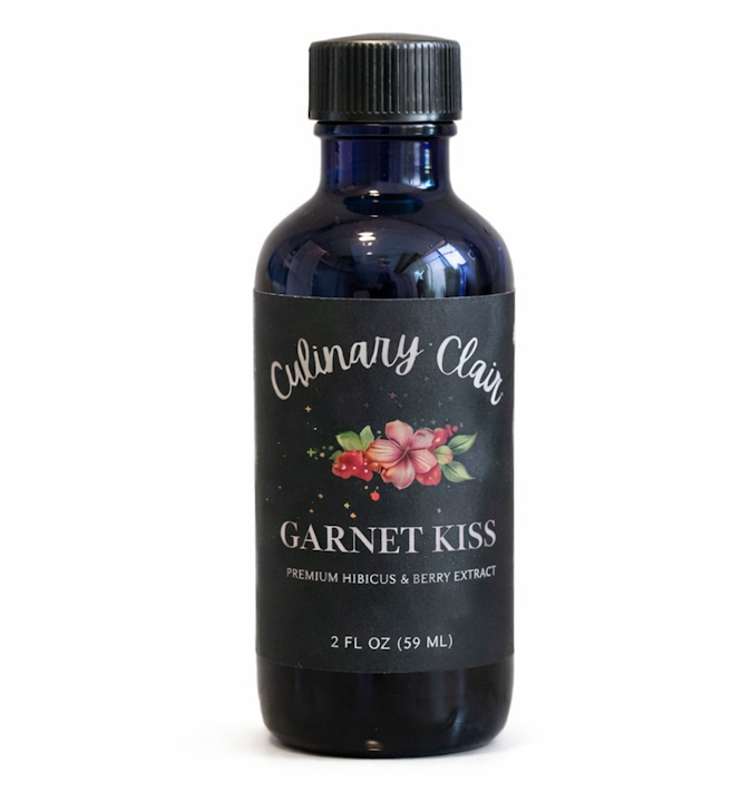 A dark blue glass bottle with a black label reading 