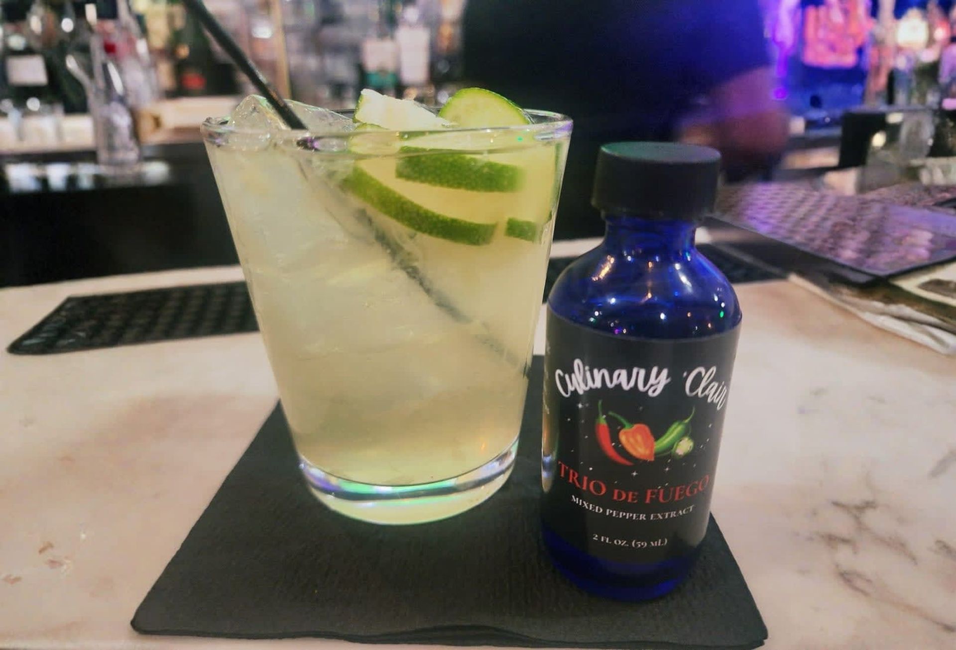 Cocktail in a glass with lime slices.