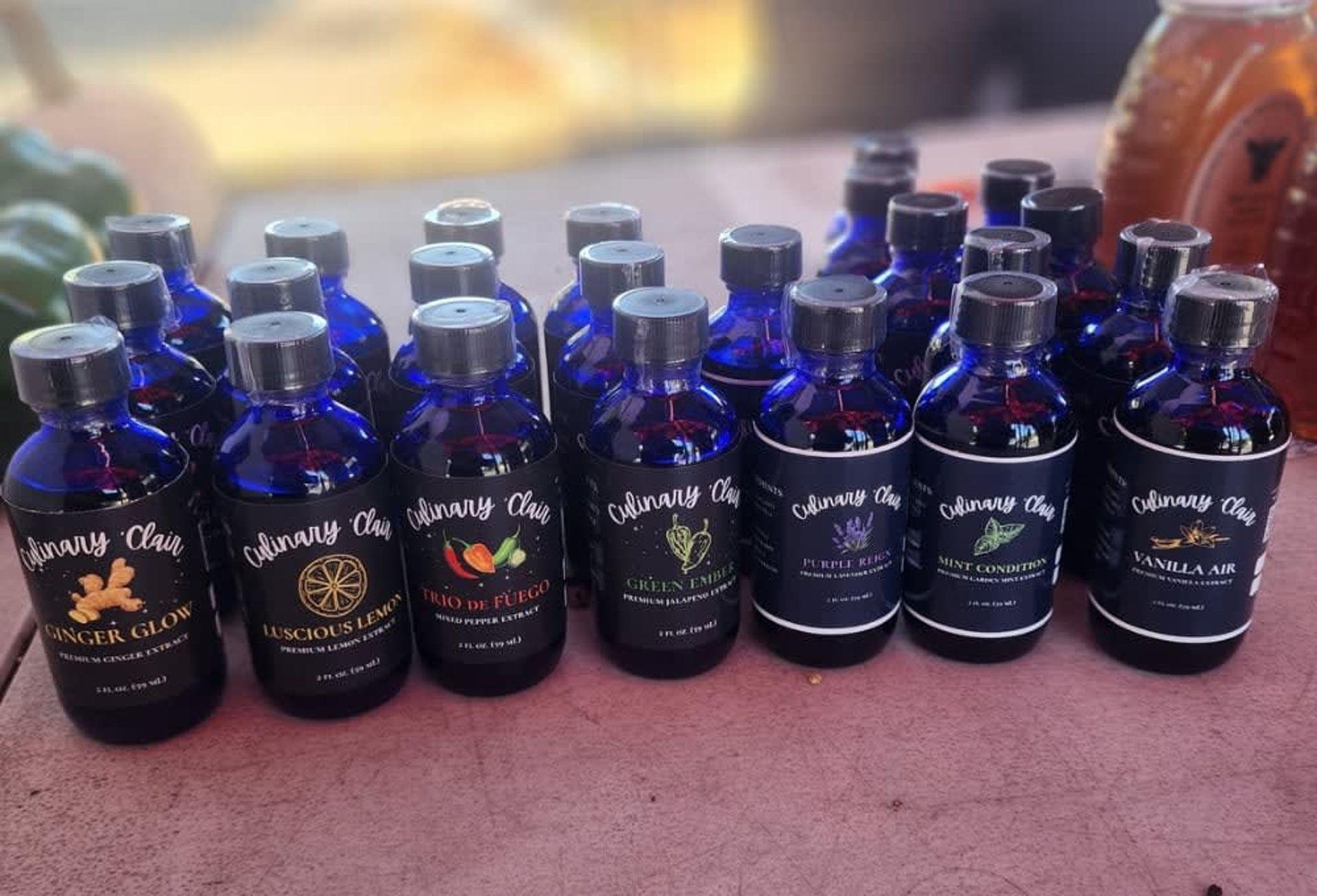 Bottles of flavored honey on display at a market.