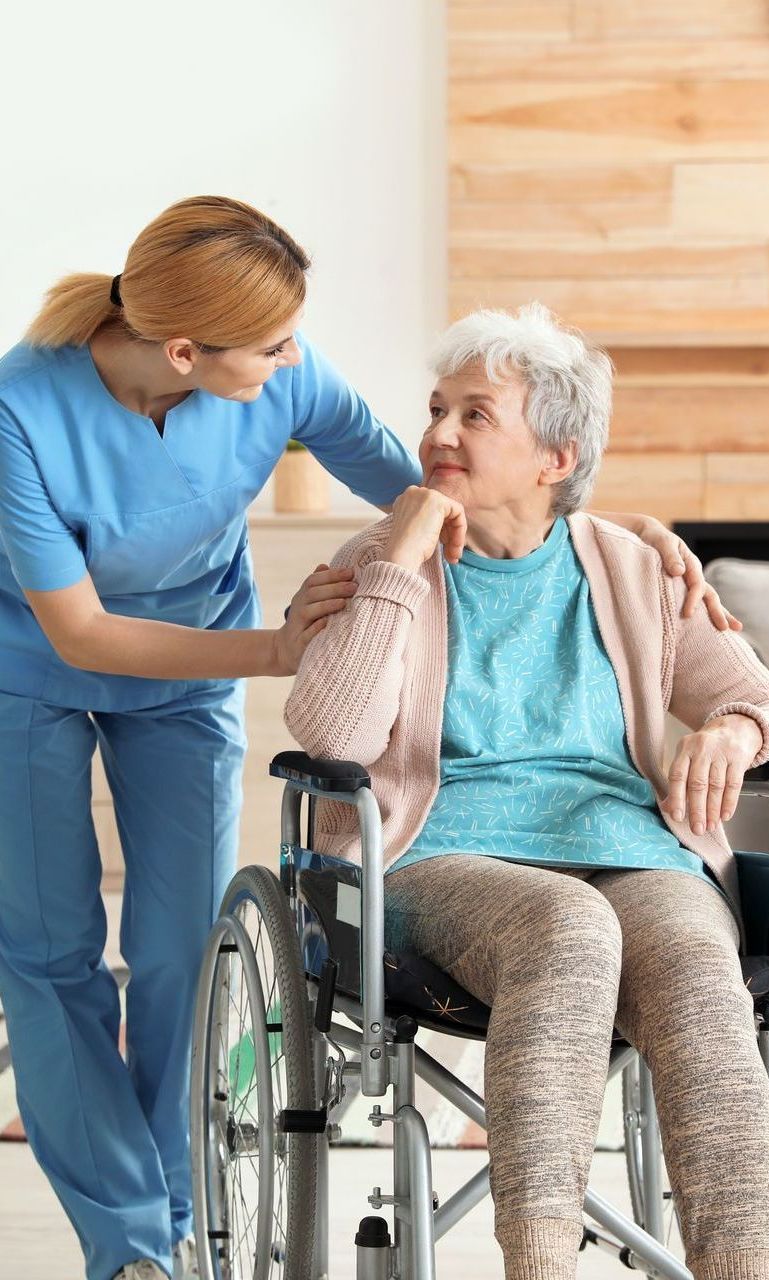 A nursing home worker assisting a patient