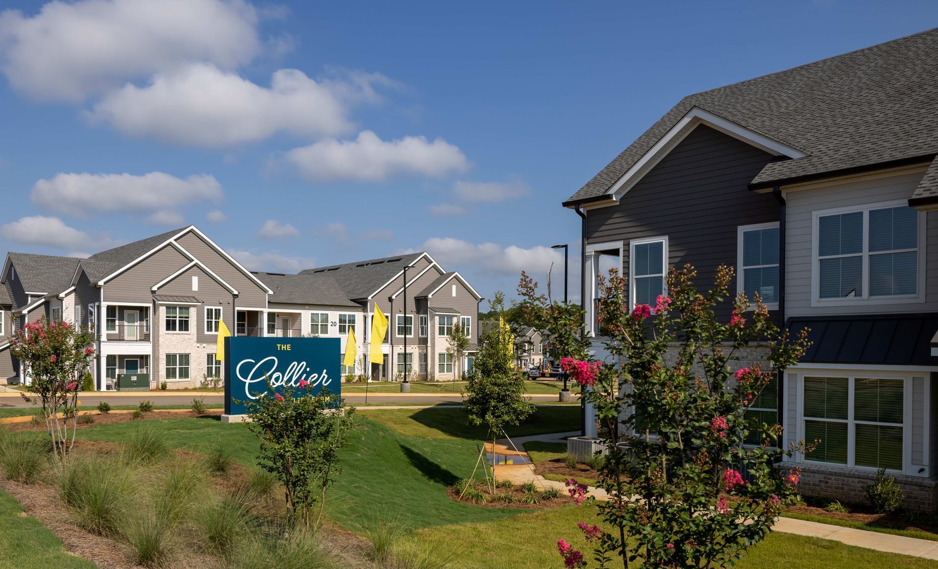 Modern apartment complex with sign 