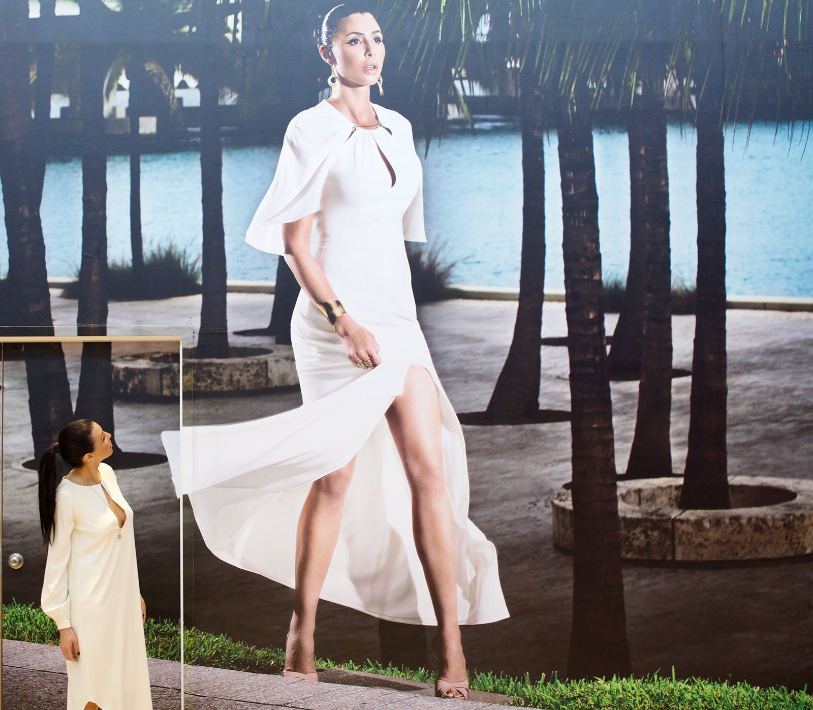 Drena De Niro poses with the larger-than-life hoarding wall art installation.