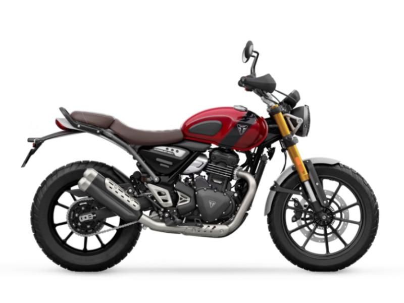 Red and black Triumph Scrambler rental motorcycle with gold forks on white background.