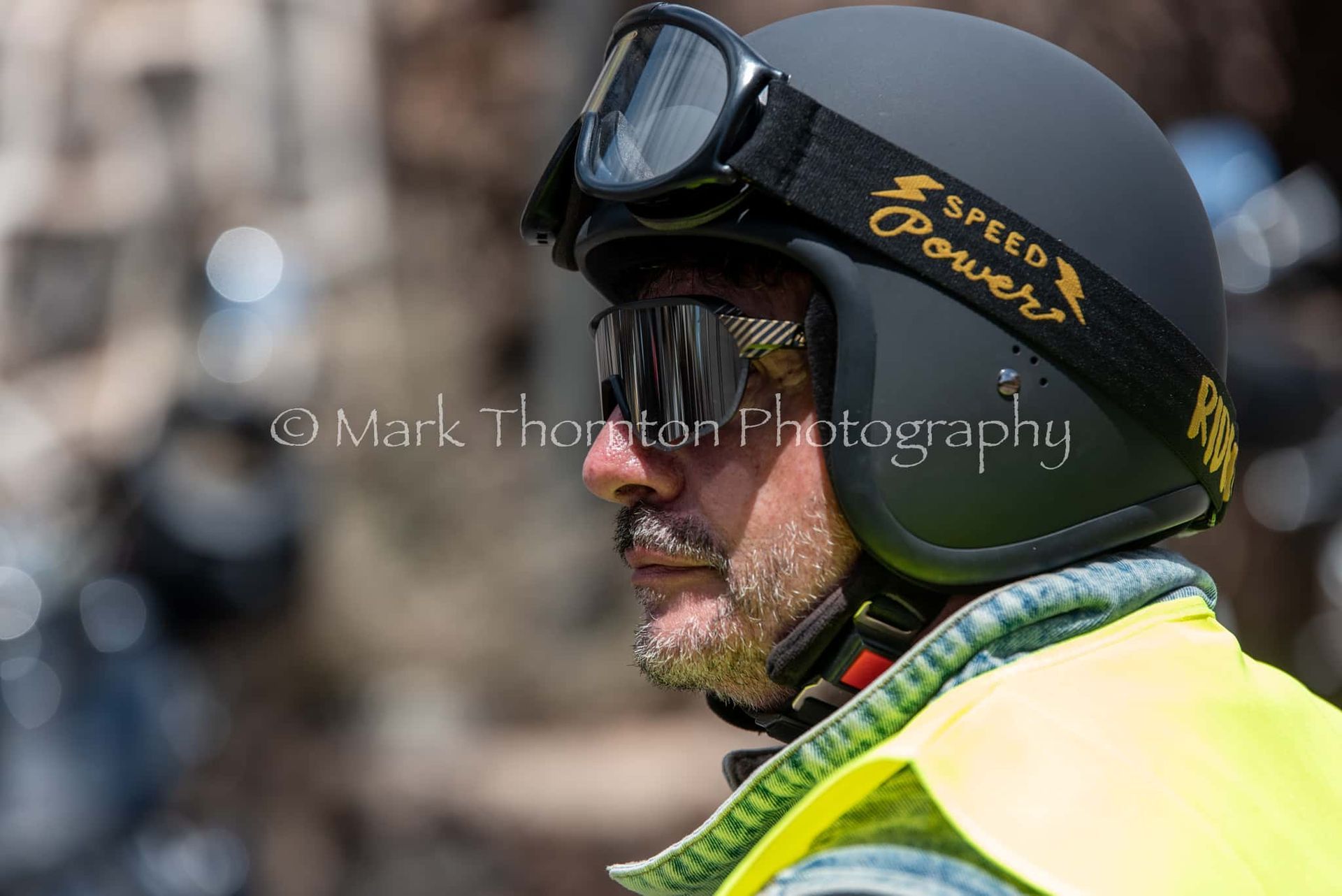 A man wearing a motorcycle helmet and goggles.