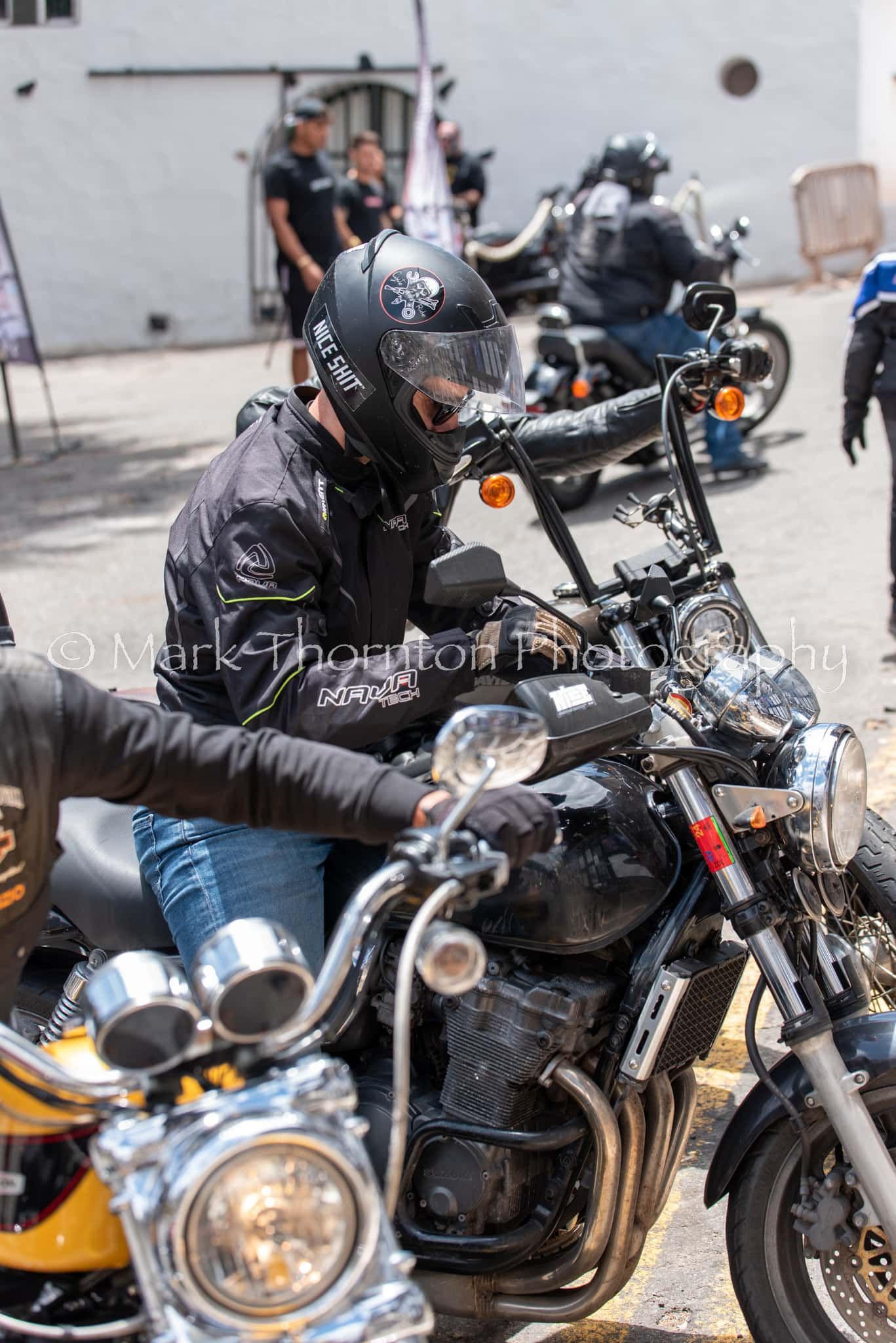 A man is sitting on a motorcycle wearing a helmet.