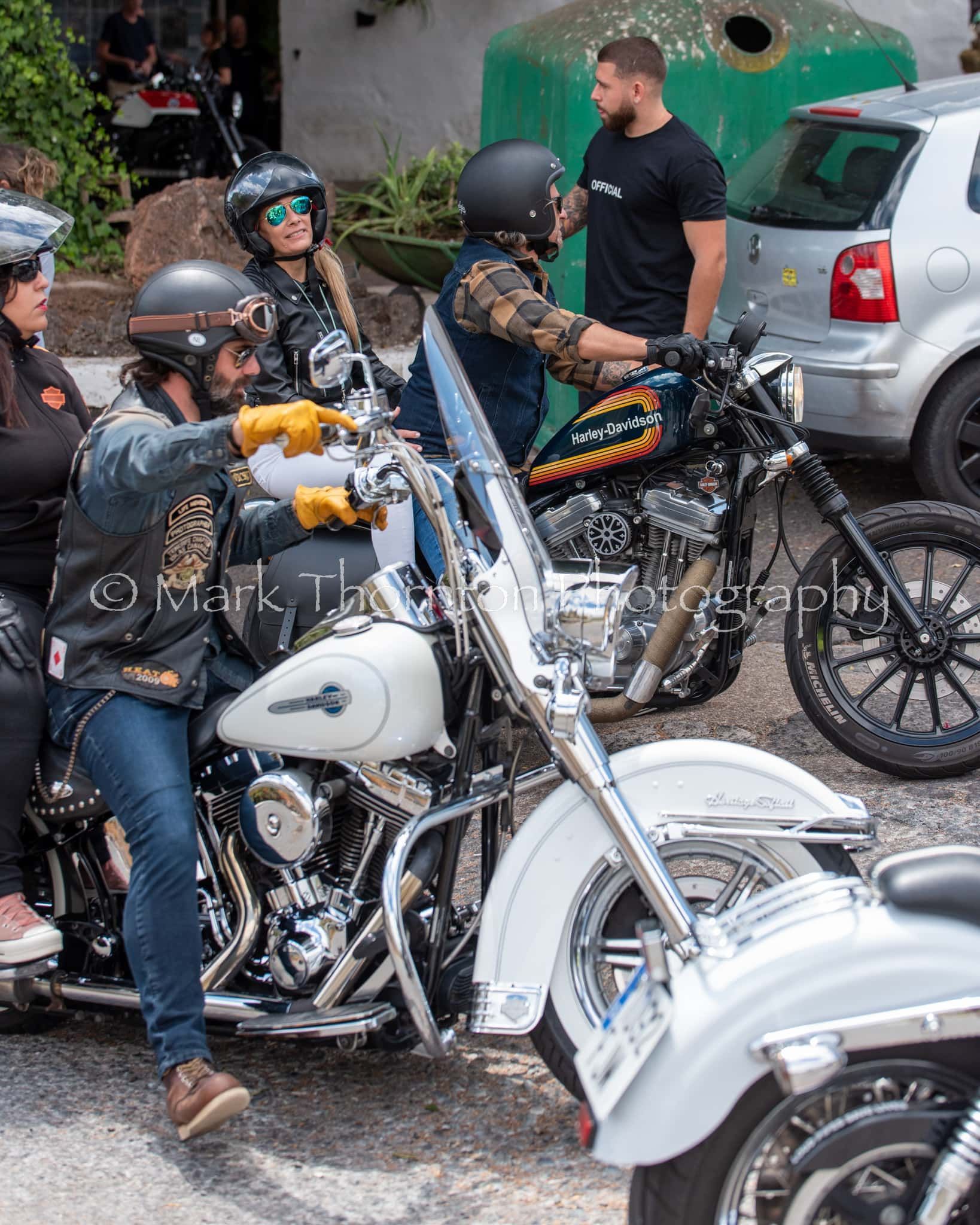 A group of people are riding motorcycles on a street.