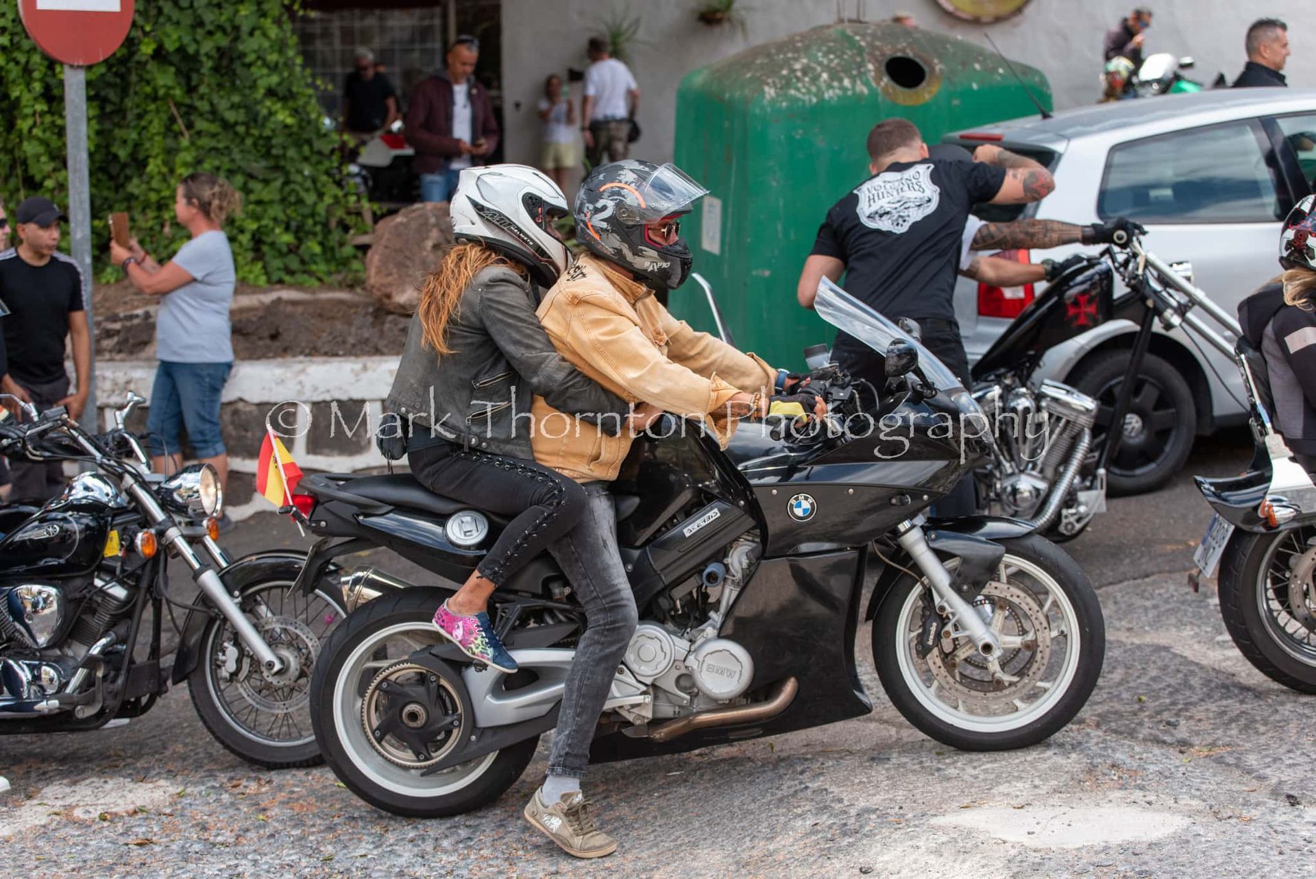 A group of people are riding motorcycles on a street.