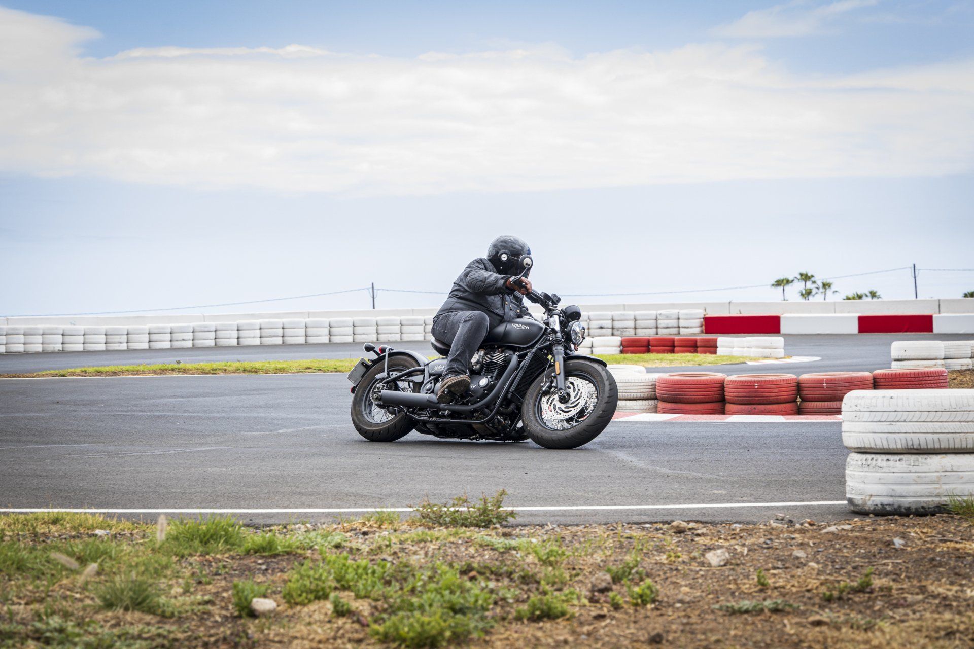 A man is riding a motorcycle on a race track.