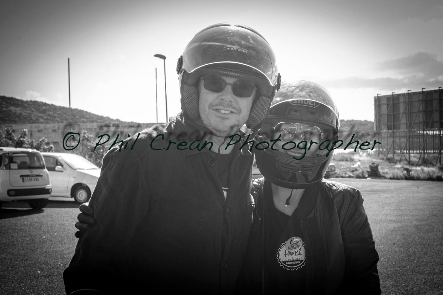 A black and white photo of a man and woman wearing helmets