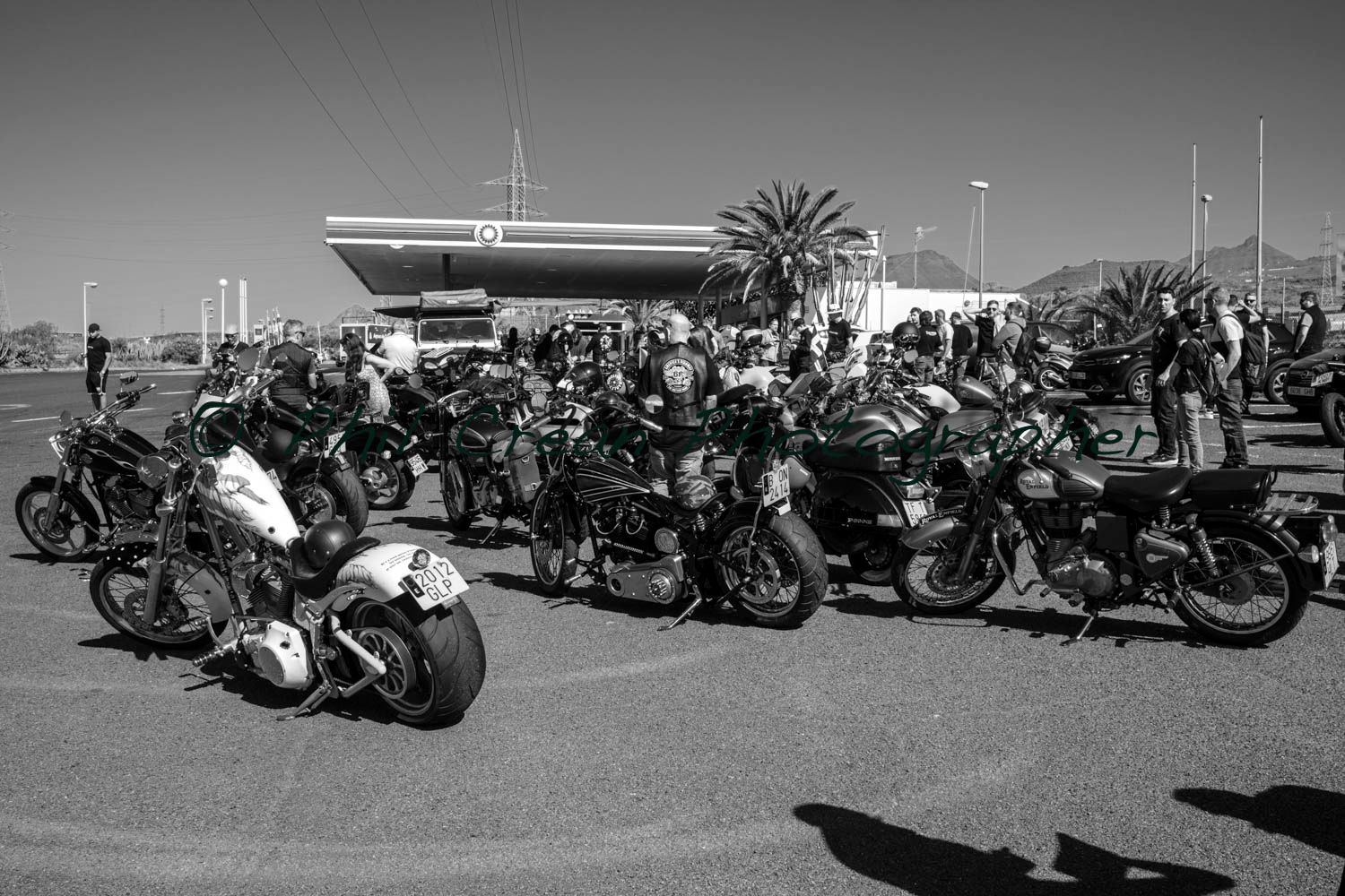 A group of motorcycles are parked in front of a gas station