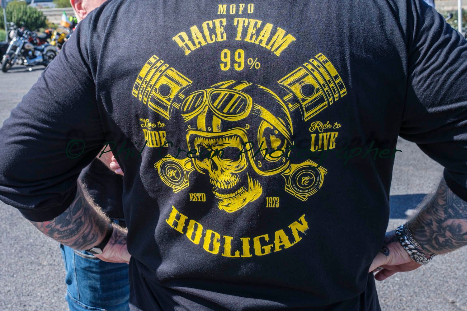 A man wearing a black shirt that says race team on it