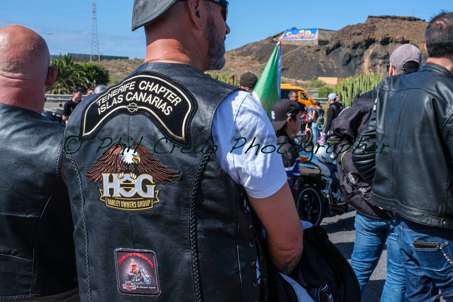 A man wearing a leather vest with the word hog on it