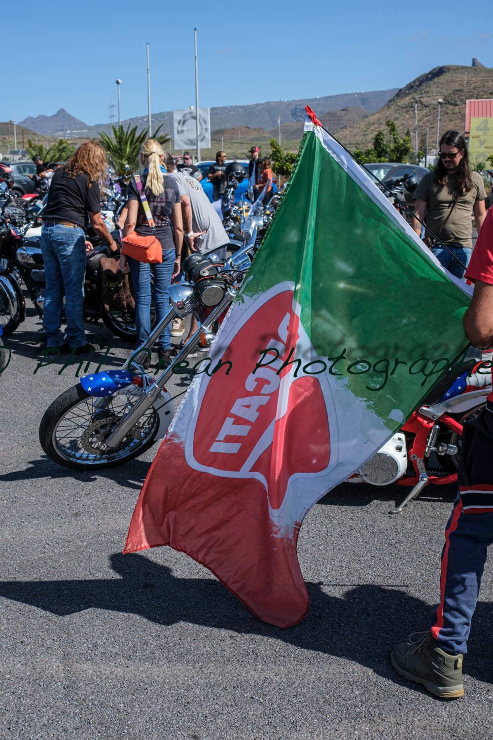 A man holding a flag that says ita on it