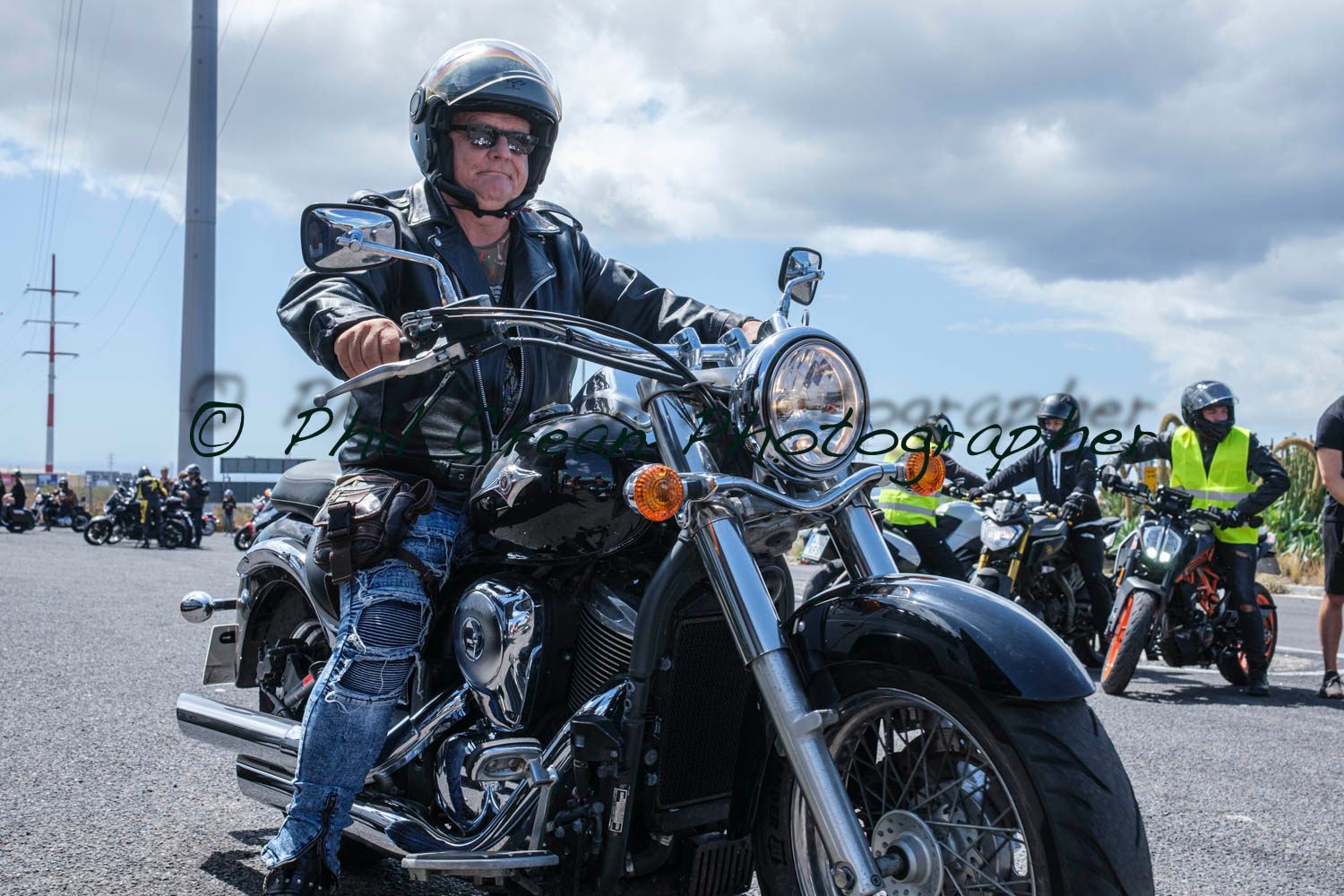 A man is riding a motorcycle on a road.