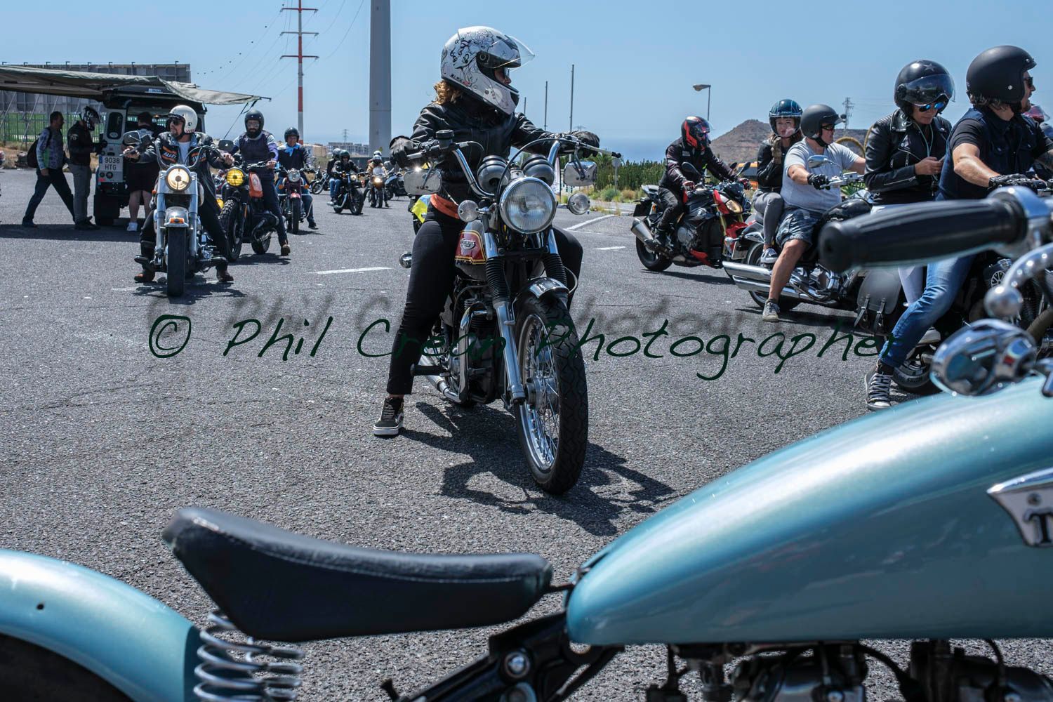 A group of people are riding motorcycles down a road.