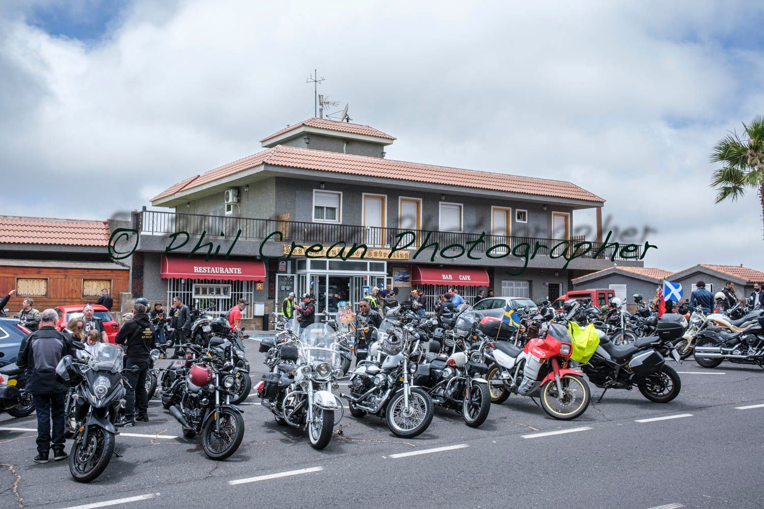A bunch of motorcycles are parked in front of a building