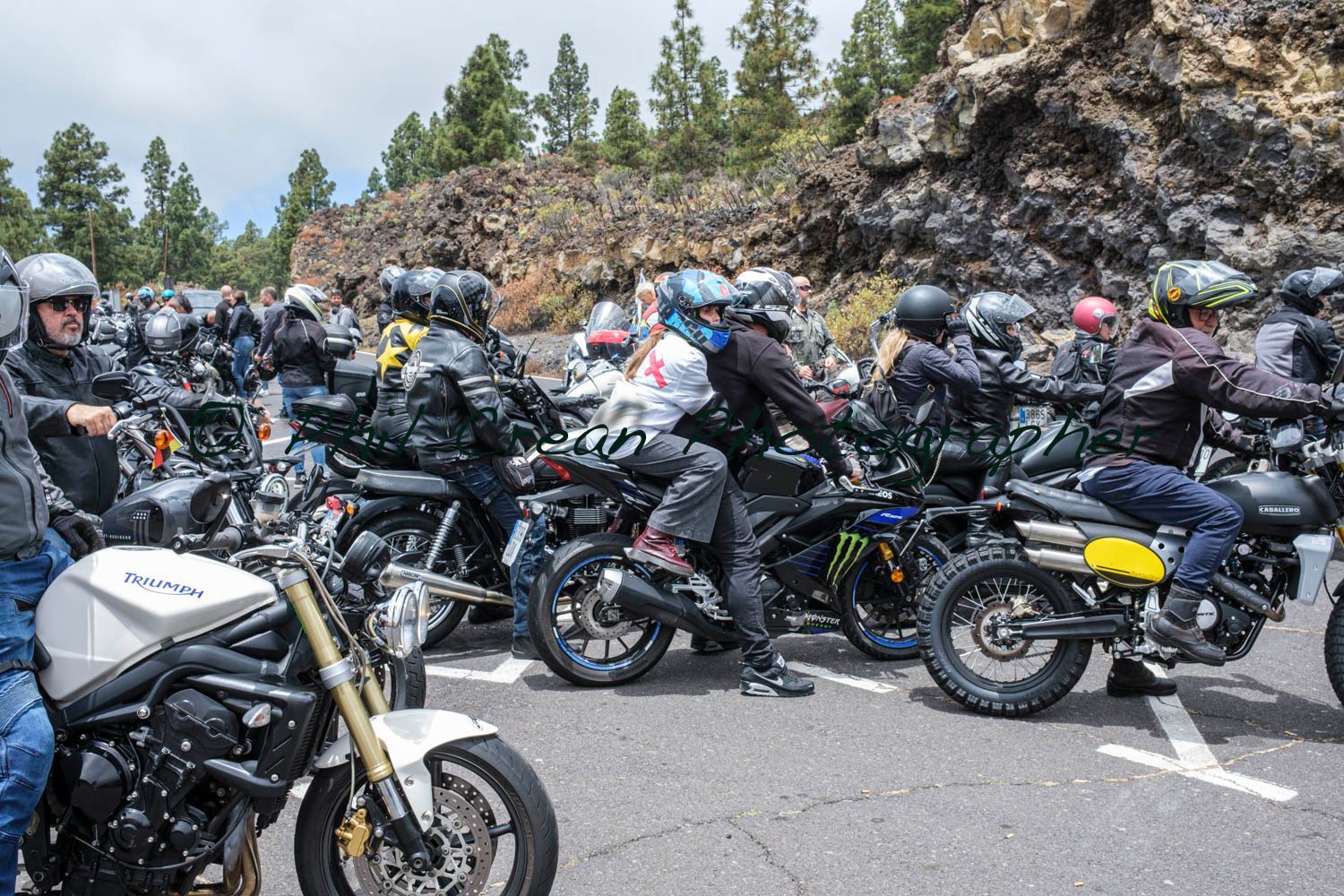 A group of people are riding motorcycles down a road.