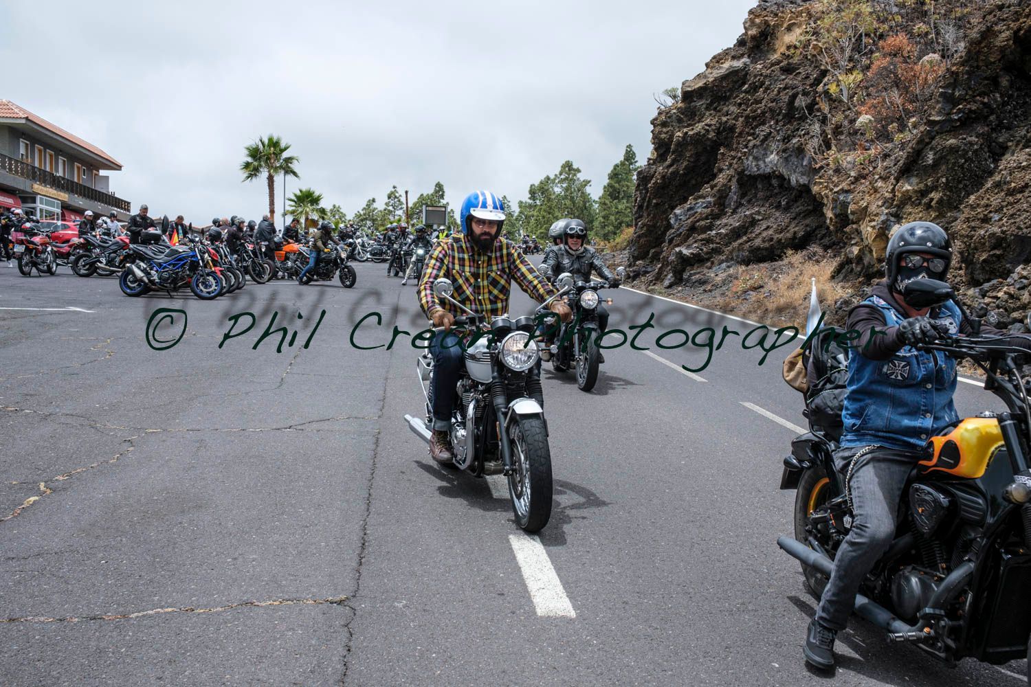 A group of people are riding motorcycles down a road