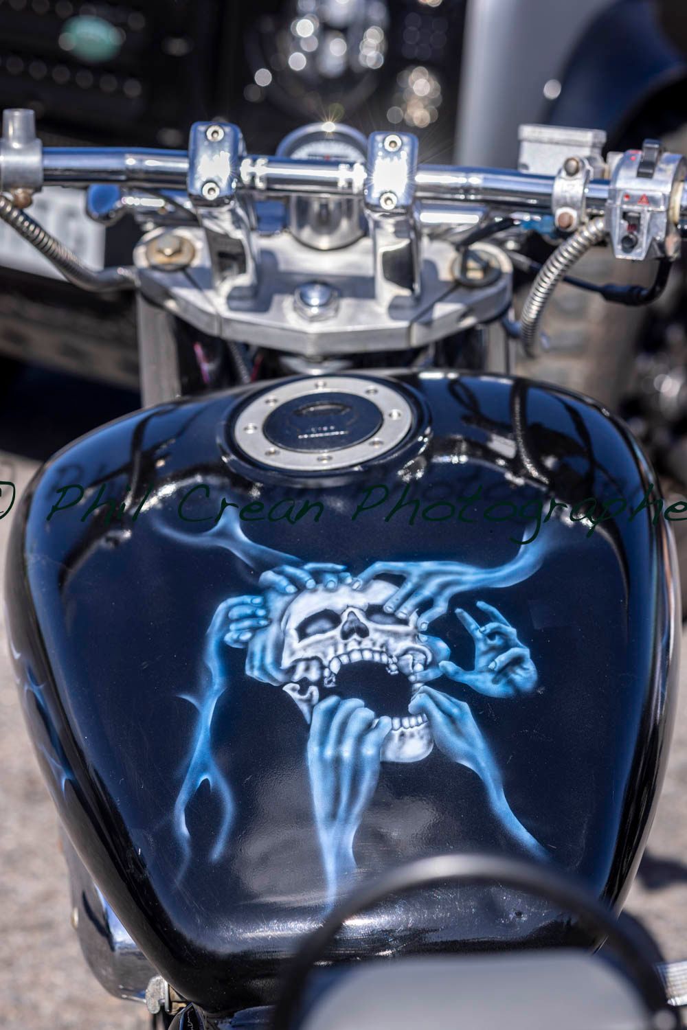 A motorcycle with a skull painted on the tank