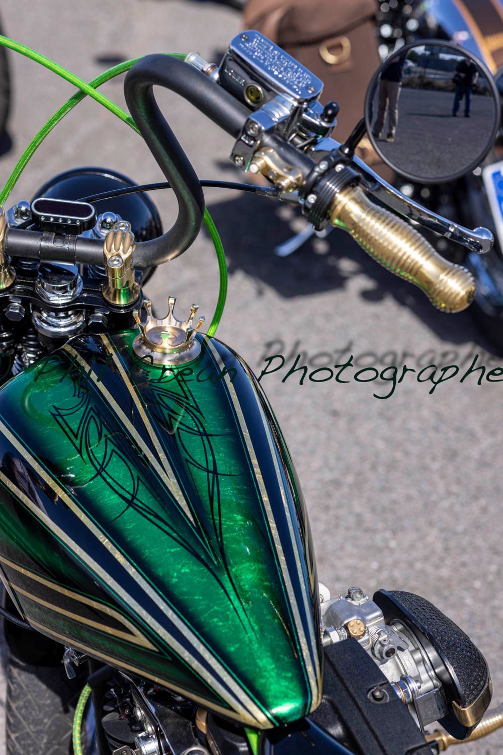 A green and gold motorcycle with a crown on the tank
