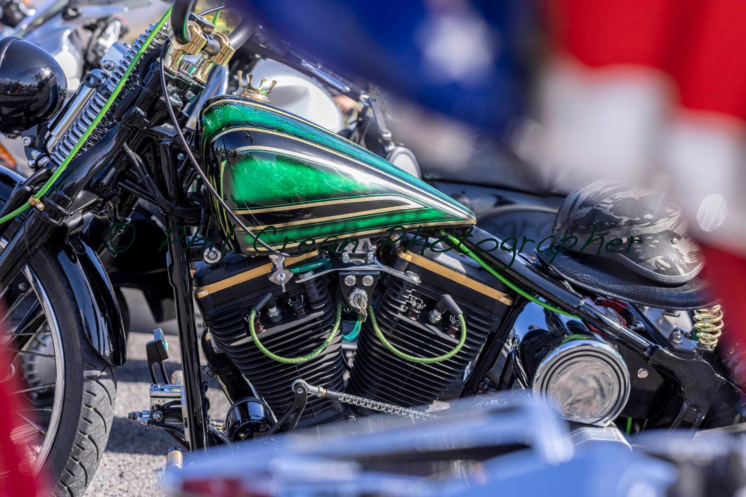 A motorcycle with a green tank is parked next to another motorcycle.