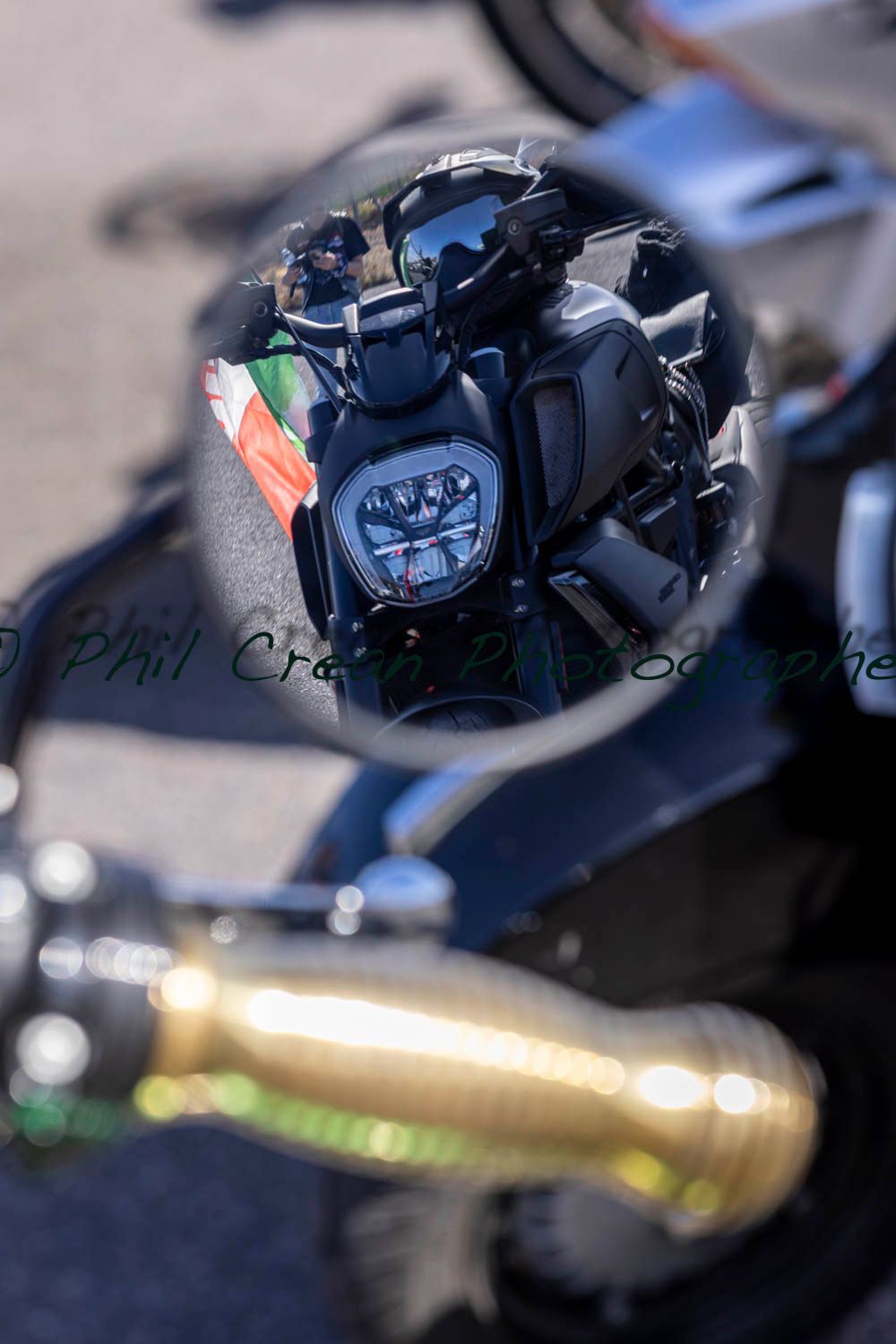 A motorcycle is reflected in a rear view mirror