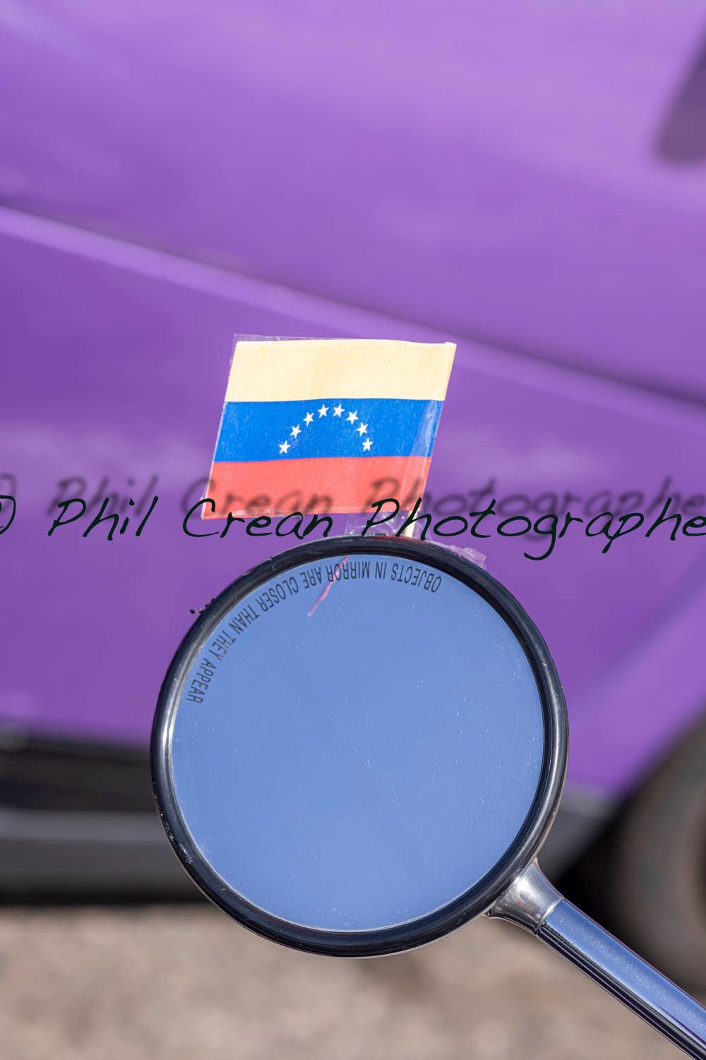 A rear view mirror with a russian flag on it