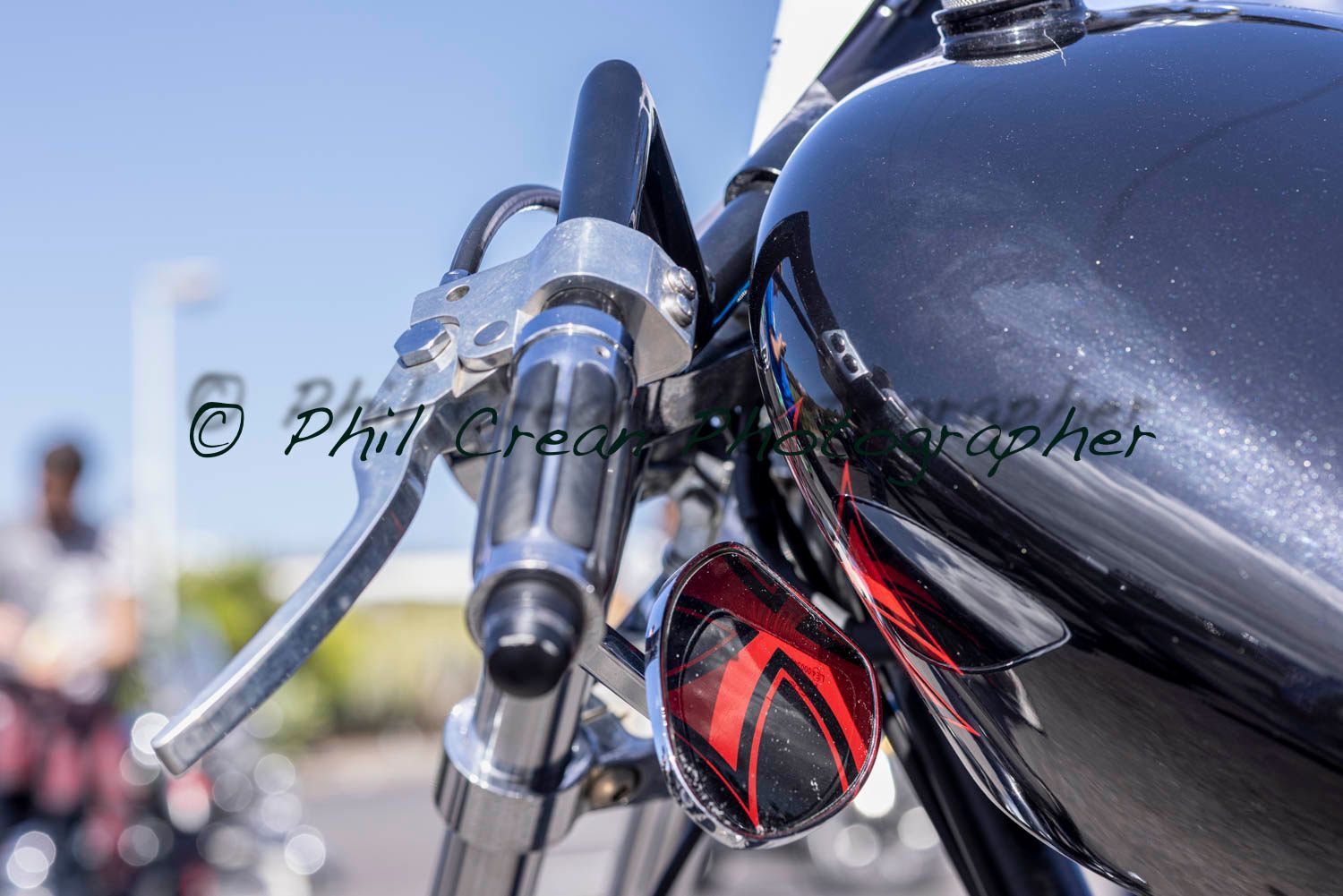 A close up of a motorcycle 's handlebars and gas tank