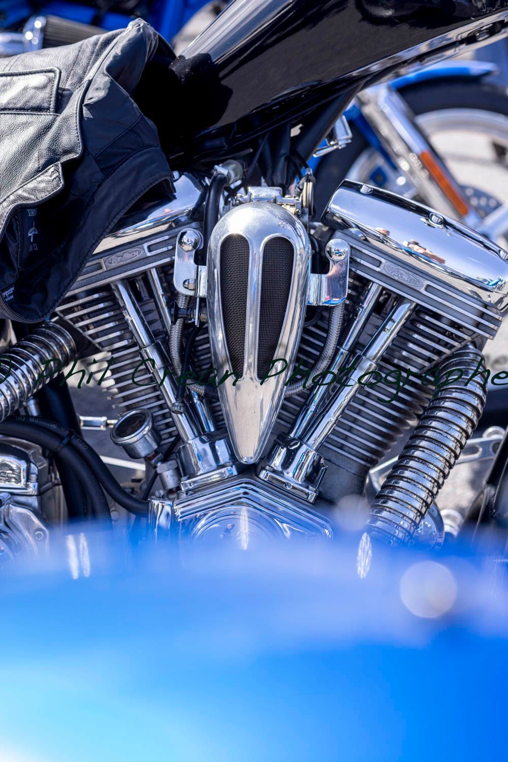 A close up of the engine of a blue motorcycle