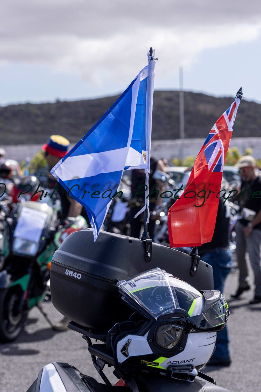 A motorcycle with a helmet and two flags on it.