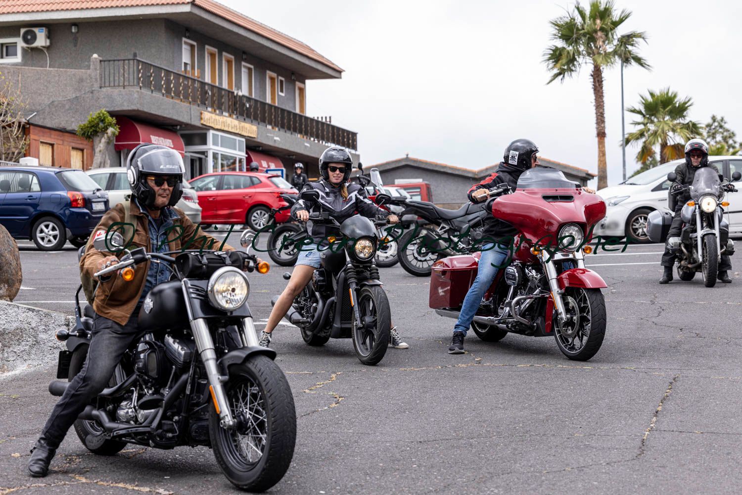 A group of people are riding motorcycles down a street.