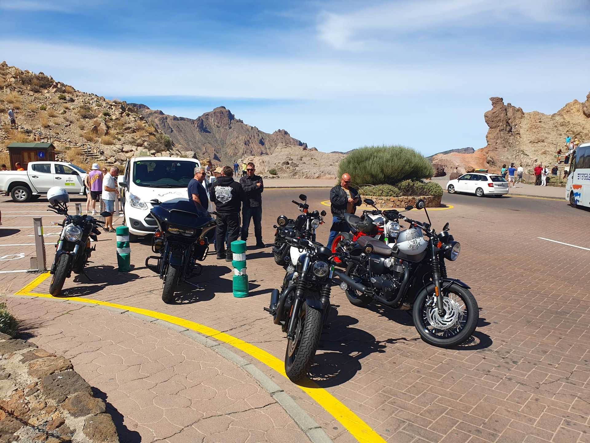 A group of motorcycles are parked on the side of the road