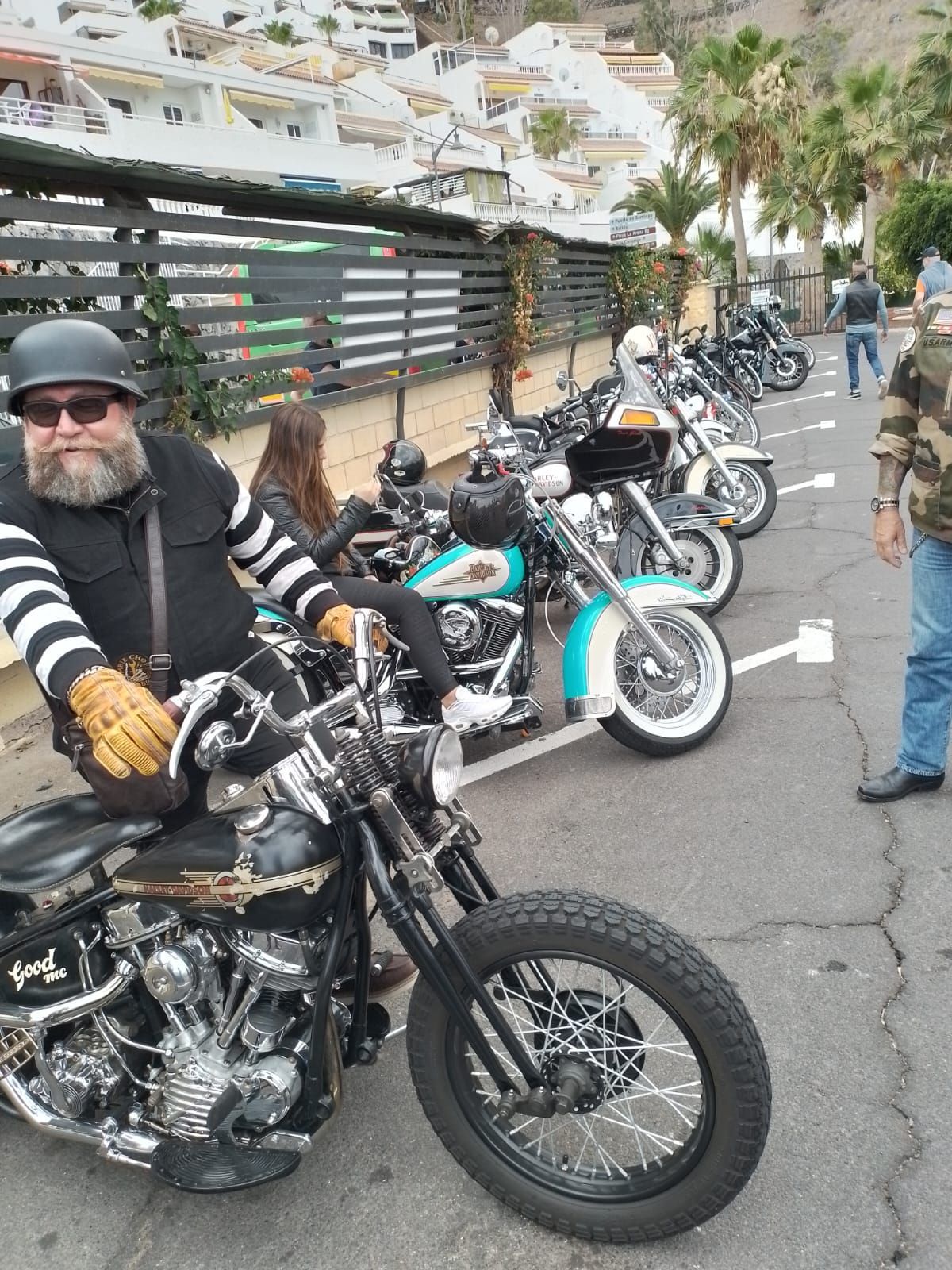 A man is riding a motorcycle in a parking lot