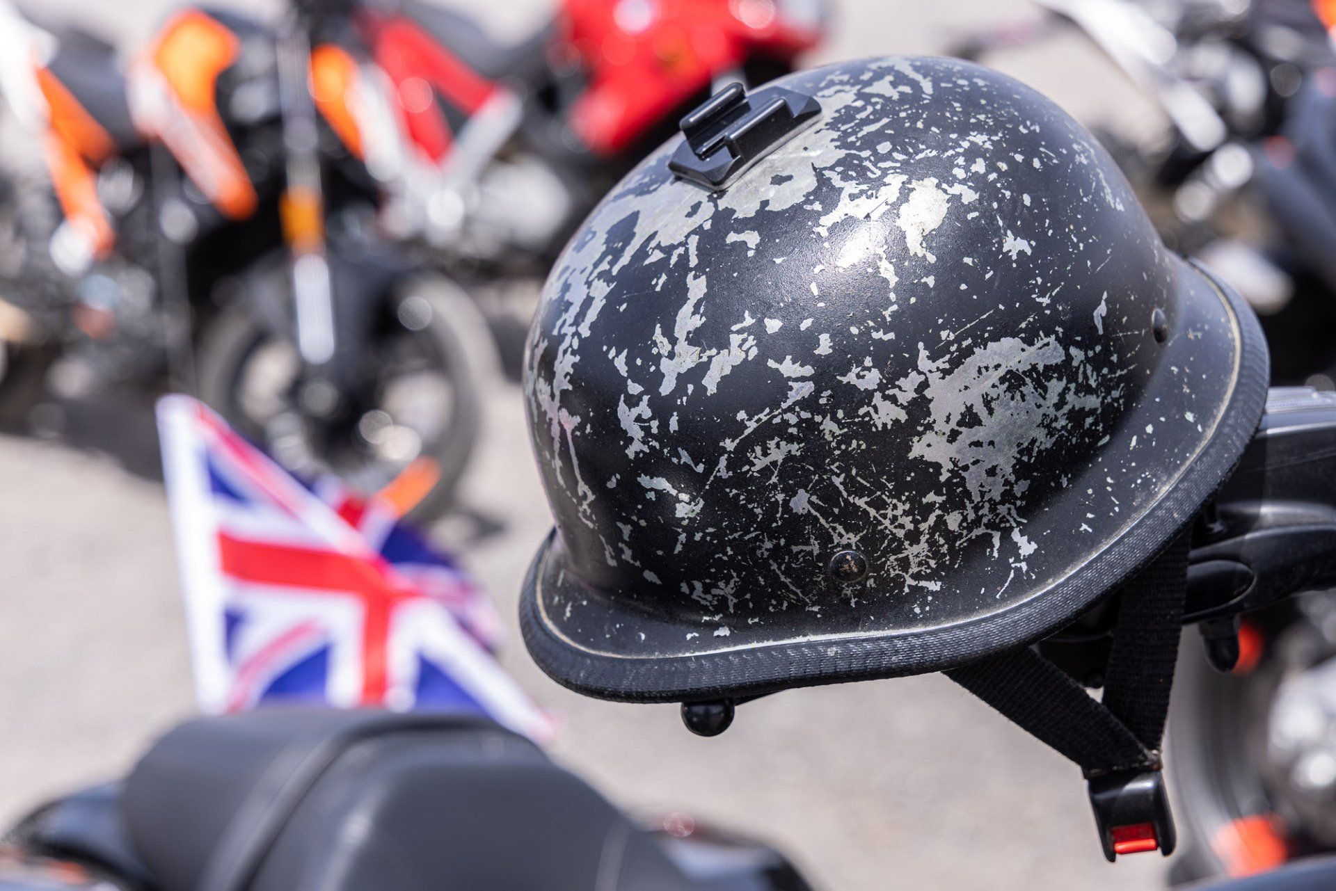 A close up of a motorcycle helmet with a british flag in the background