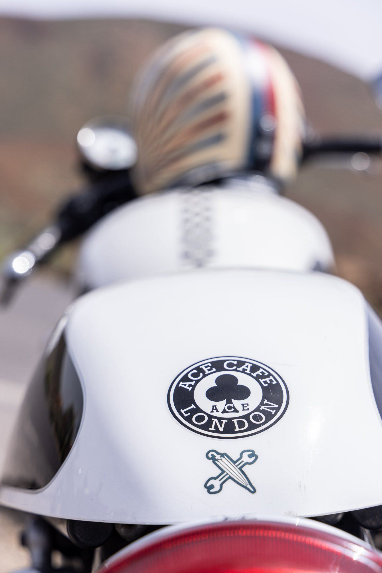 A close up of a motorcycle with a sticker on the back that says cafe racer