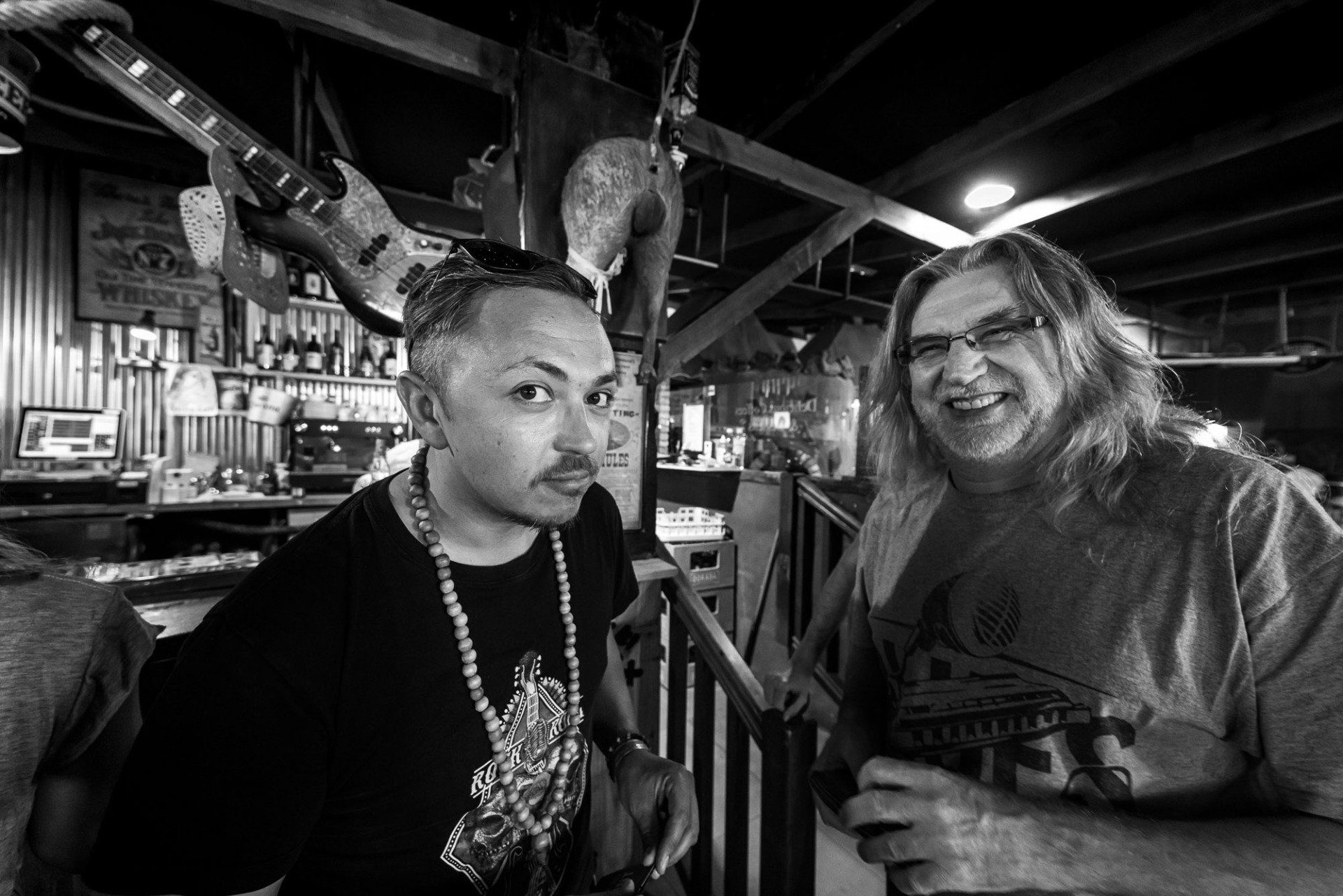 Two men are standing next to each other in a black and white photo.