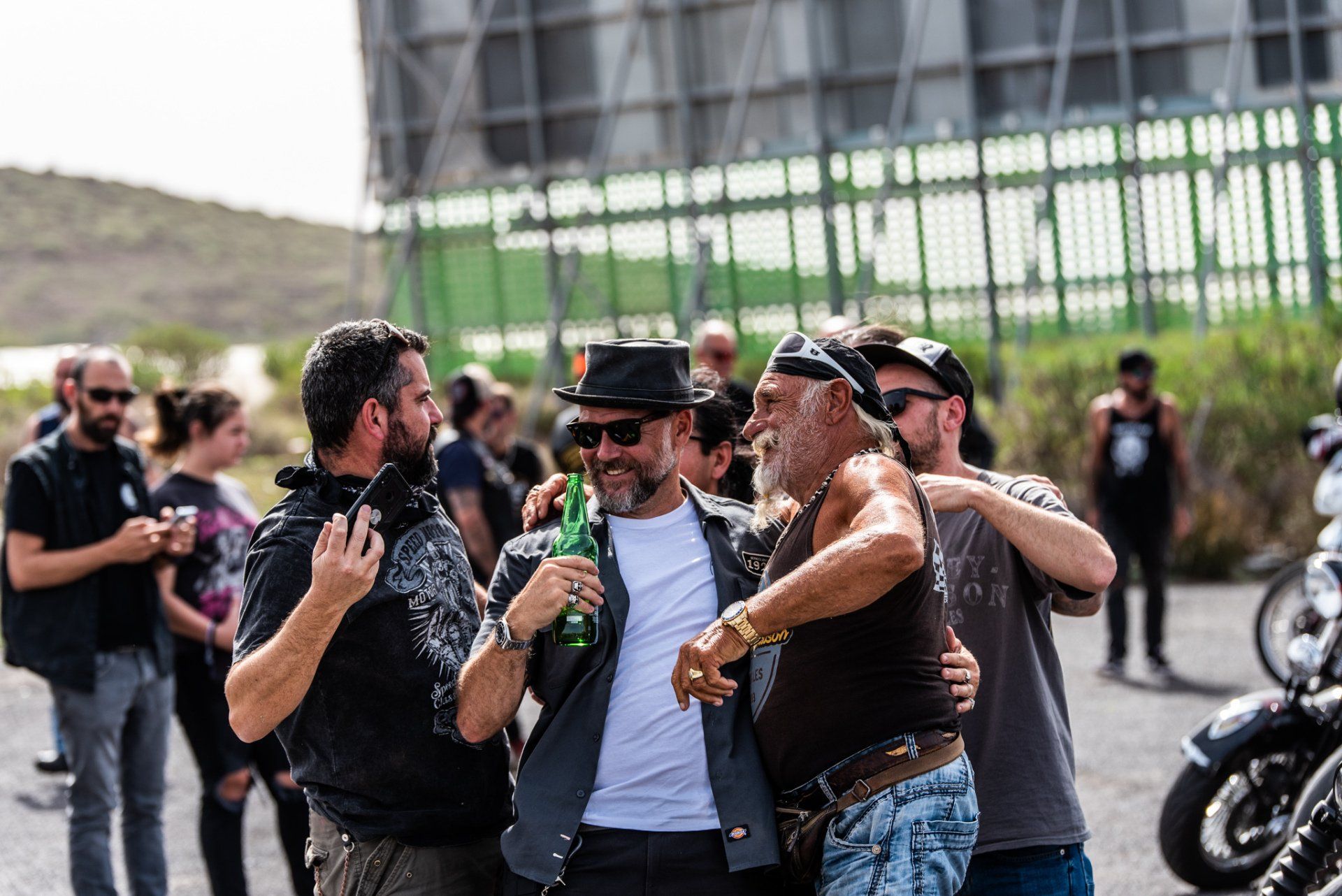 A group of men are standing next to each other in a parking lot.