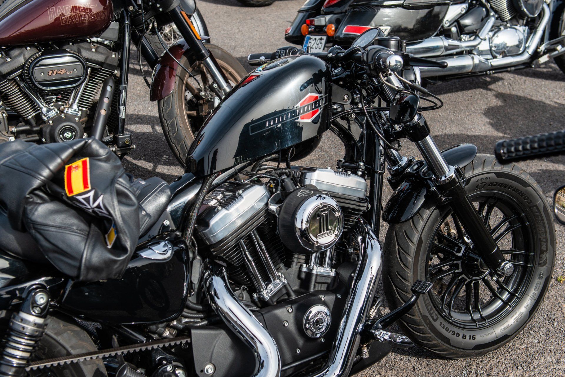 A row of harley davidson motorcycles are parked in a parking lot.