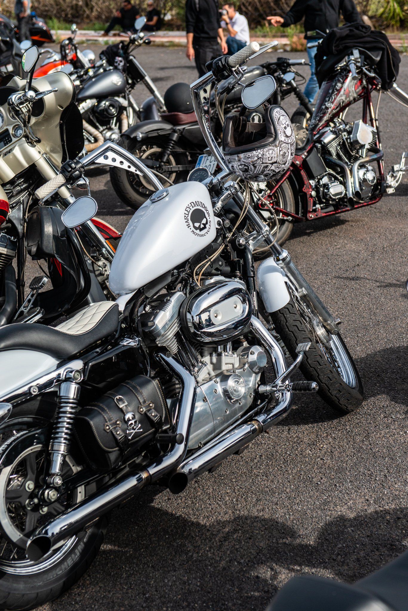 A row of motorcycles are parked on the side of the road.